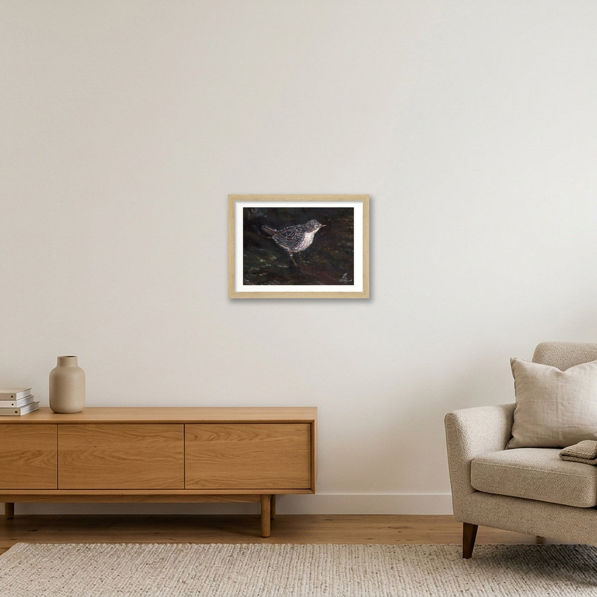 Framed juvenile dipper fine art print by artist E.L. Heywood displayed in a minimalist living room, showcasing an original oil painting of British wildlife in a contemporary interior.